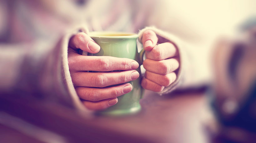 Woman with a warm cup of tea.